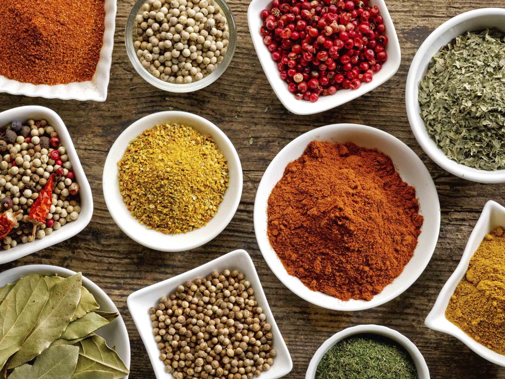 various kinds of spices on wooden table